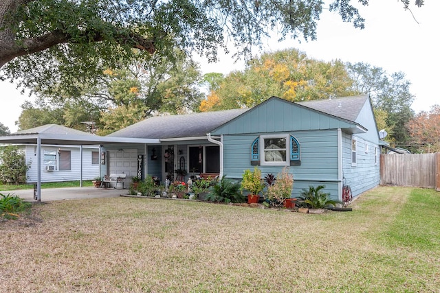 view of front of property with a front yard and a carport