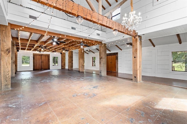 garage featuring ceiling fan and wooden walls