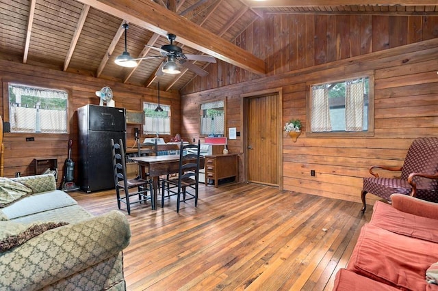 living room with wood ceiling, plenty of natural light, and lofted ceiling with beams