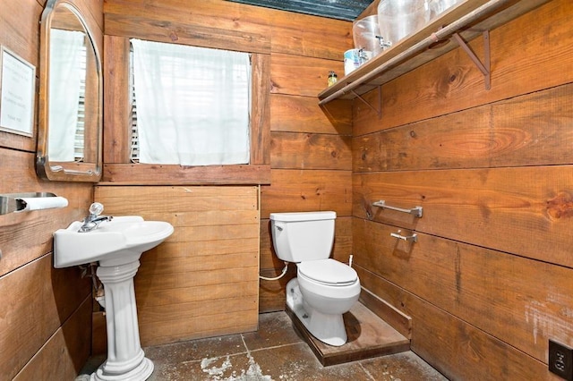 bathroom with toilet and wooden walls