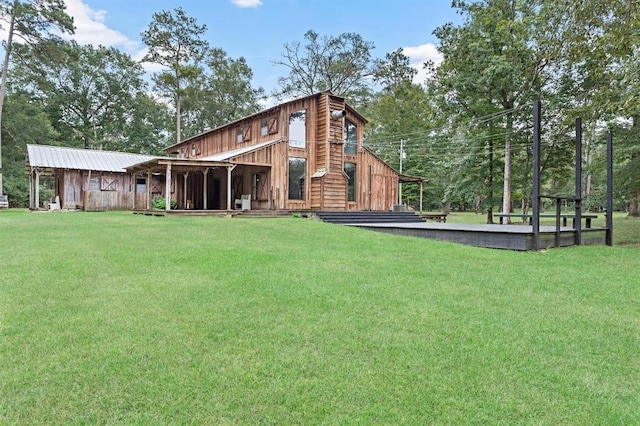 rear view of house featuring a yard