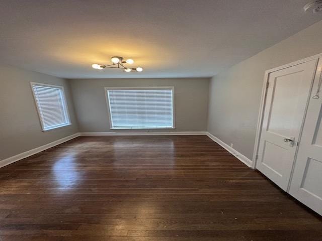 unfurnished room featuring dark hardwood / wood-style flooring