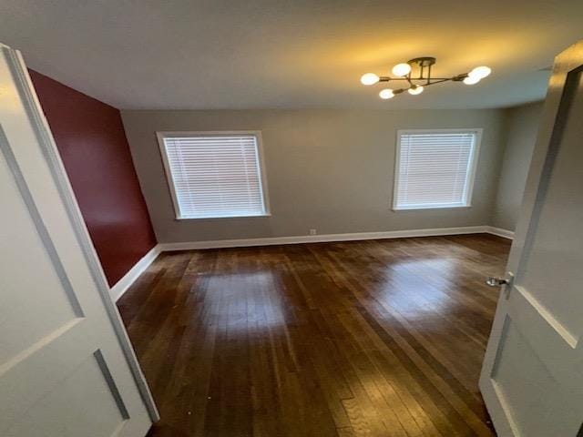 empty room with dark hardwood / wood-style flooring