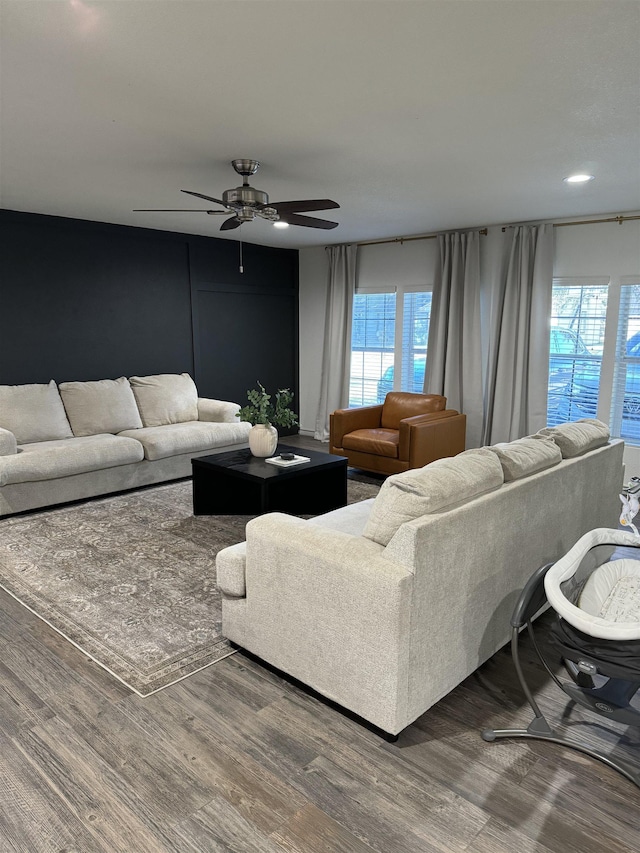 living room with hardwood / wood-style floors and ceiling fan