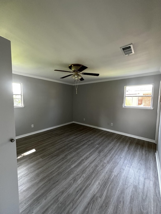 spare room featuring dark hardwood / wood-style flooring, ceiling fan, and crown molding