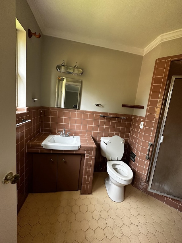 bathroom with toilet, vanity, tile walls, and ornamental molding