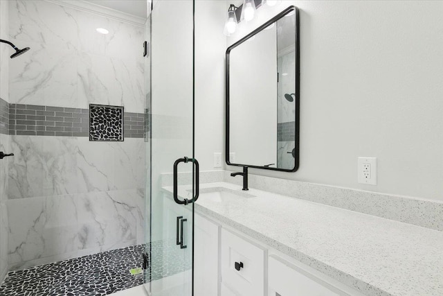 bathroom with vanity and a shower with door