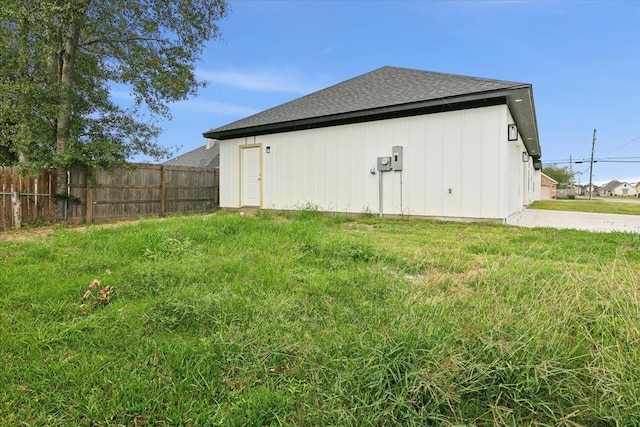 view of side of home featuring a yard