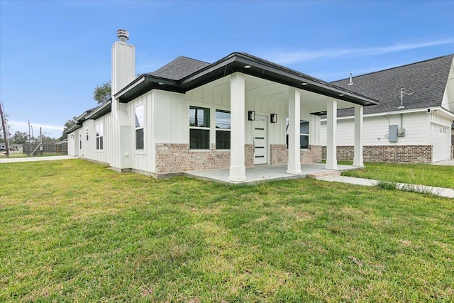 rear view of house with a lawn