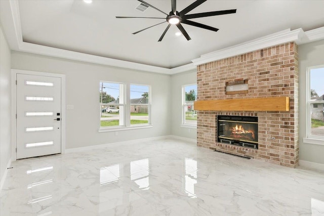 unfurnished living room featuring ceiling fan and a brick fireplace