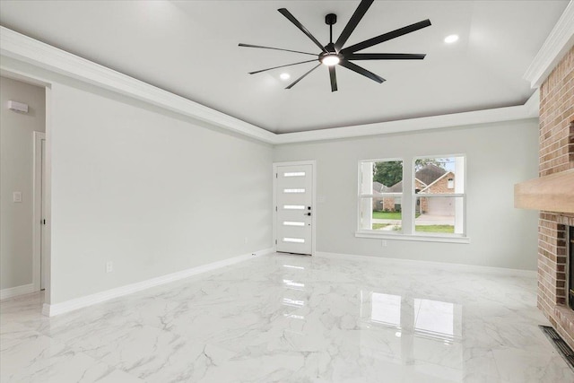 unfurnished living room with ceiling fan, crown molding, and a brick fireplace