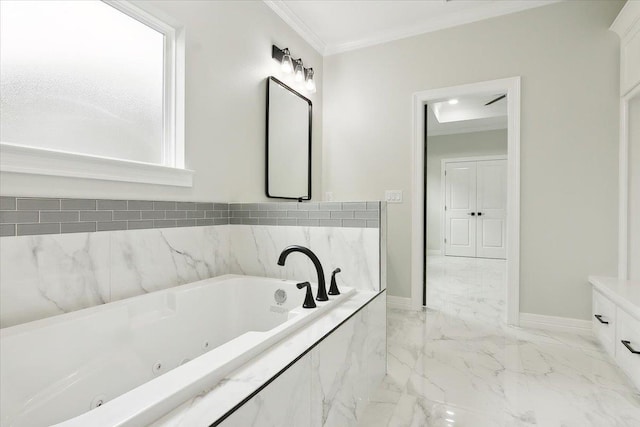 bathroom featuring tiled tub, vanity, and ornamental molding