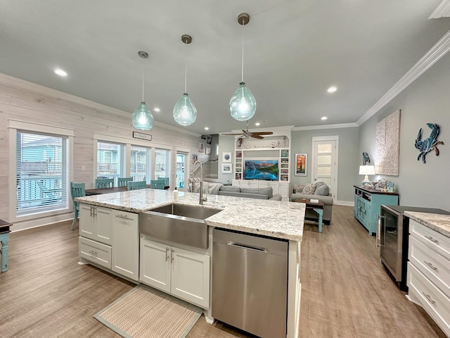 kitchen featuring a sink, light wood-type flooring, ornamental molding, and dishwasher