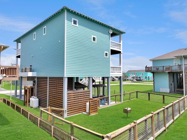 view of property exterior with a lawn and fence