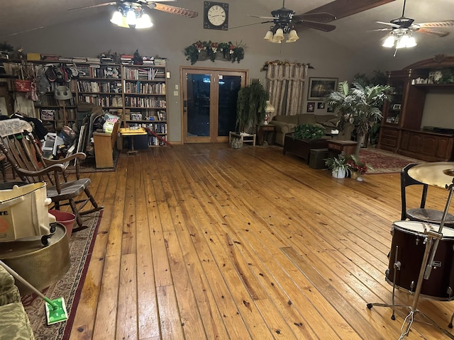 living room featuring french doors, light hardwood / wood-style floors, and lofted ceiling