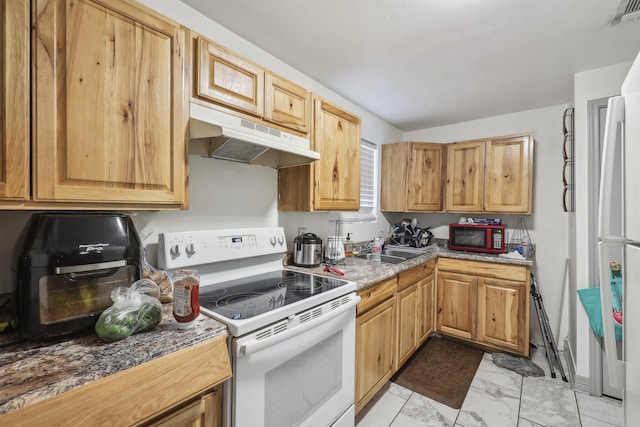 2725 29th St, Port Arthur, TX 77640 - kitchen featuring white appliances, under cabinet range hood, light marble finish floors, and a sink