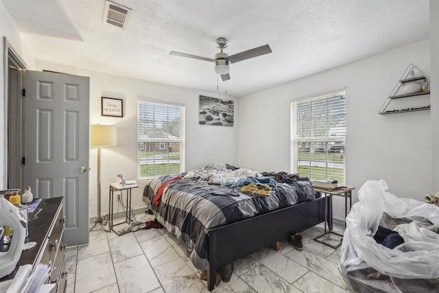2725 29th St, Port Arthur, TX 77640 - bedroom with light marble finish floors, multiple windows, and a ceiling fan
