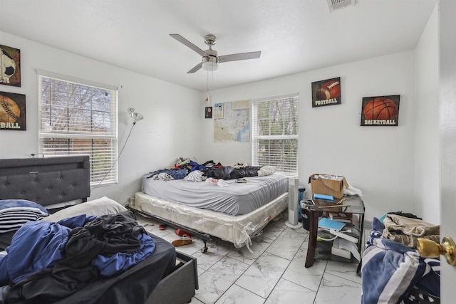 2725 29th St, Port Arthur, TX 77640 - bedroom featuring light marble finish floors and a ceiling fan