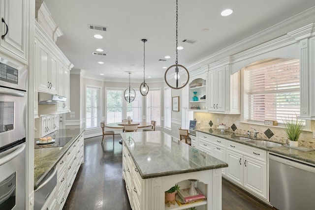 2250 Savannah Trce, Beaumont, TX 77706 - kitchen with stainless steel appliances, open shelves, a warming drawer, white cabinets, and decorative backsplash