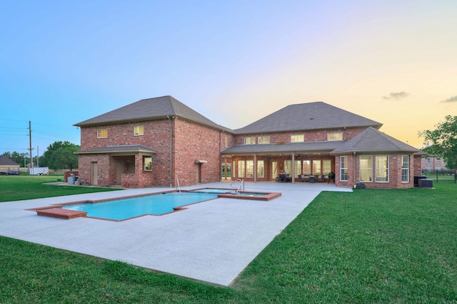 2250 Savannah Trce, Beaumont, TX 77706 - view of swimming pool featuring a patio, a lawn, and a pool with connected hot tub