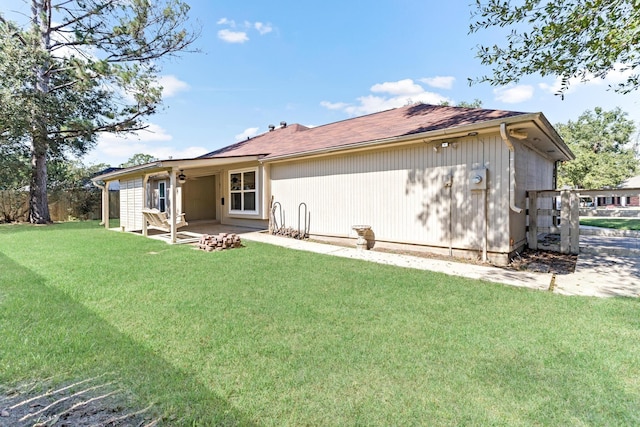 rear view of house with a patio area and a yard