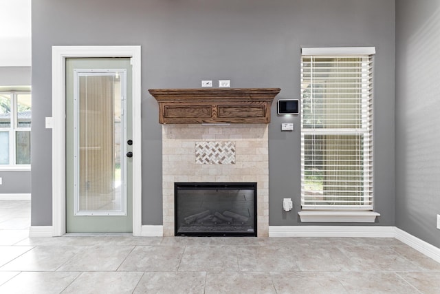 12715 Koawood Ln, Beaumont, TX 77713 - unfurnished living room featuring a tiled fireplace and tile patterned flooring