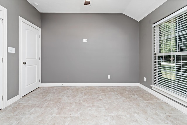 empty room featuring vaulted ceiling and ceiling fan