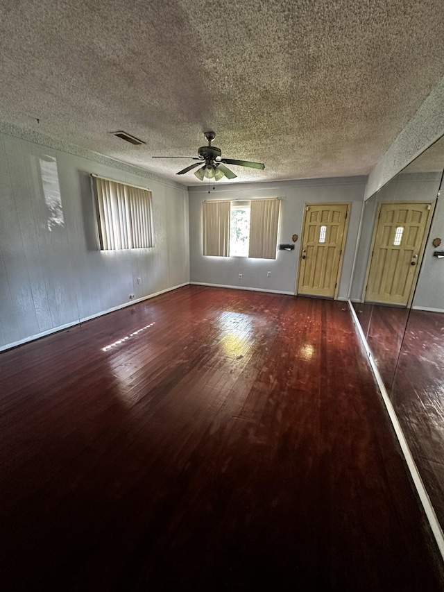 1901 14th St, Port Arthur, TX 77640 - unfurnished living room with hardwood / wood-style floors, a textured ceiling, and a ceiling fan