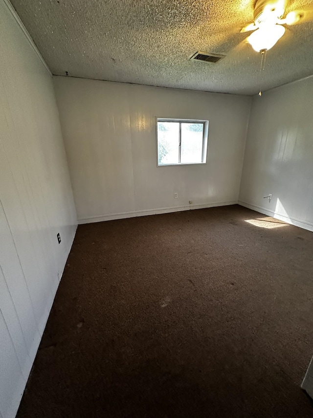 1901 14th St, Port Arthur, TX 77640 - empty room featuring dark colored carpet and a textured ceiling