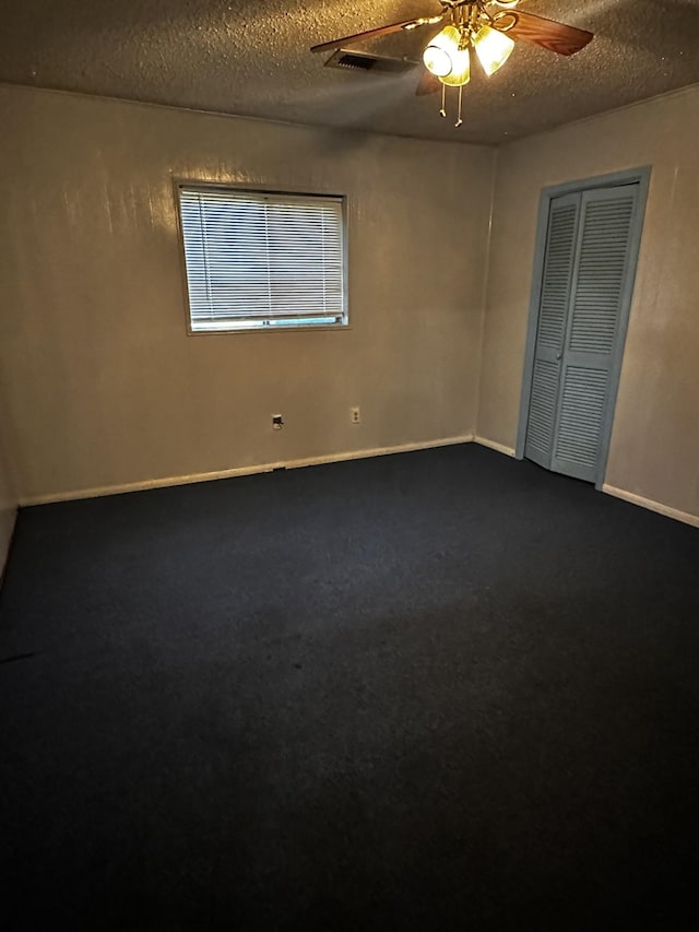 1901 14th St, Port Arthur, TX 77640 - unfurnished room with a ceiling fan, dark carpet, a textured ceiling, and baseboards