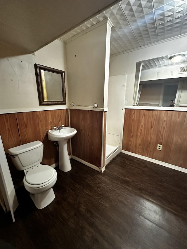 1901 14th St, Port Arthur, TX 77640 - full bathroom with wood finished floors, toilet, a shower stall, and a sink
