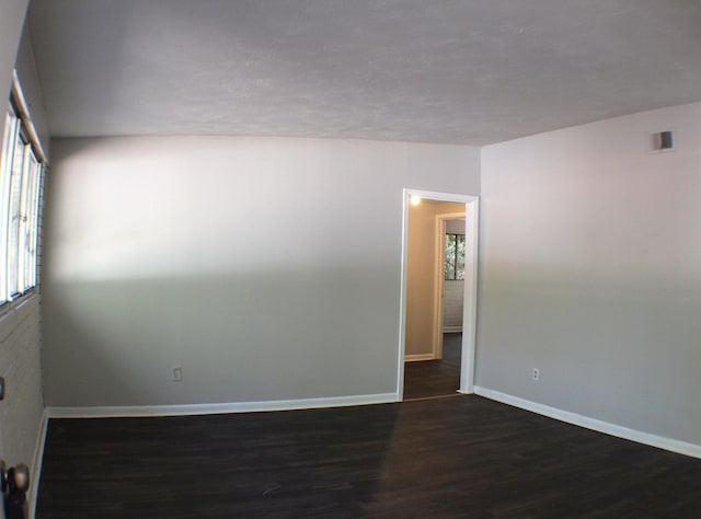 spare room with dark wood-type flooring