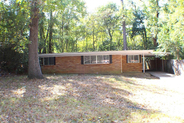 ranch-style house featuring a carport