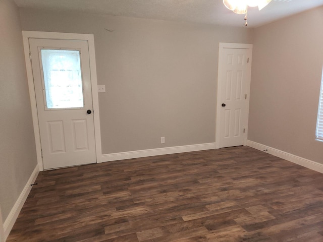 1313 Block St, Port Neches, TX 77651 - empty room with dark wood-style flooring, baseboards, and ceiling fan