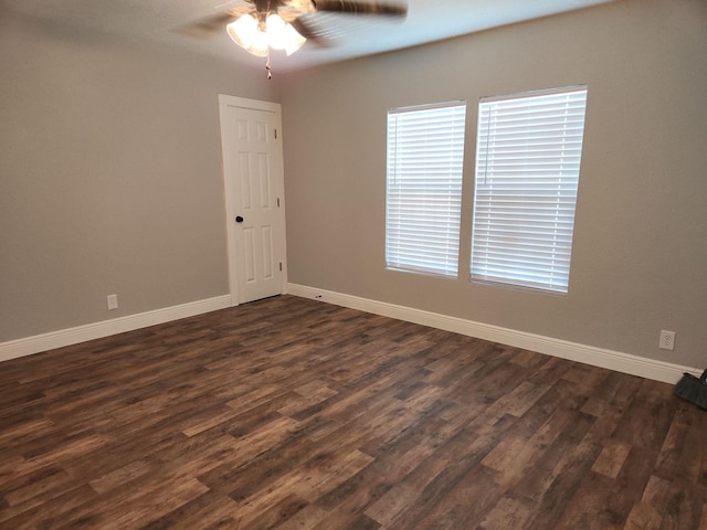 1313 Block St, Port Neches, TX 77651 - unfurnished room with ceiling fan, baseboards, dark wood-style flooring, and healthy amount of natural light
