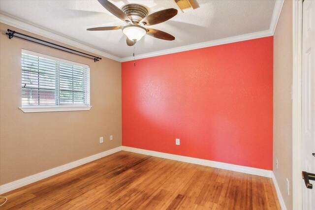 unfurnished room featuring crown molding, ceiling fan, a textured ceiling, and hardwood / wood-style flooring