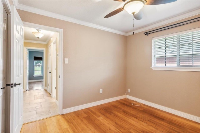 spare room featuring ceiling fan, wood-type flooring, and crown molding