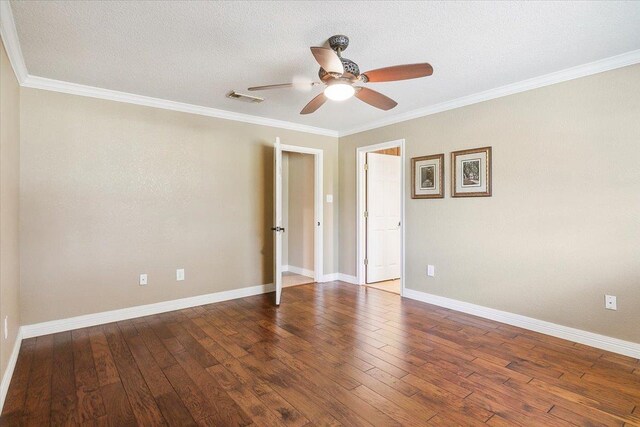 empty room featuring hardwood / wood-style floors, ceiling fan, and crown molding