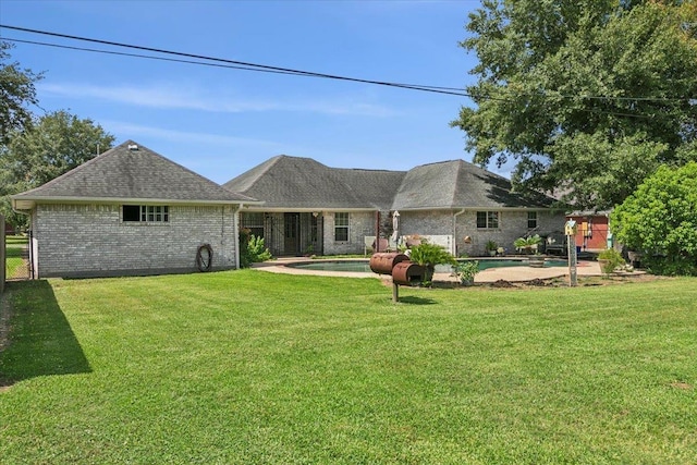 rear view of house with a yard