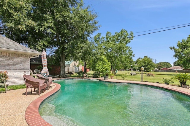 view of pool with a yard and a patio area