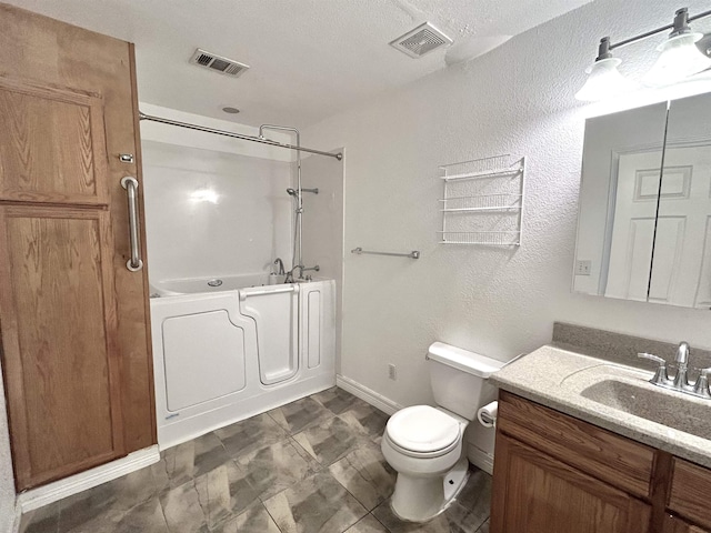 bathroom with a tub, vanity, and toilet