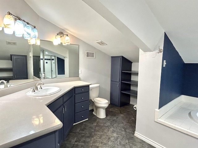 bathroom featuring vanity, toilet, lofted ceiling, and a washtub