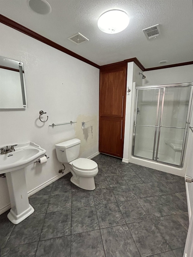 bathroom with sink, crown molding, toilet, a textured ceiling, and an enclosed shower