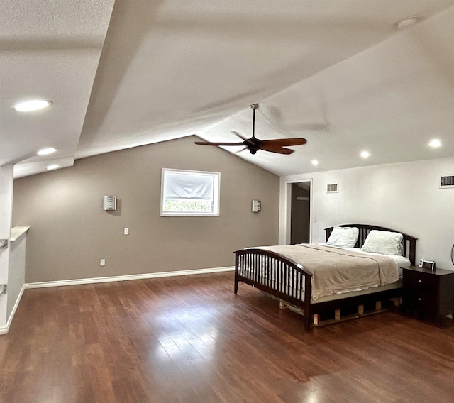 bedroom featuring dark hardwood / wood-style floors, vaulted ceiling, and ceiling fan