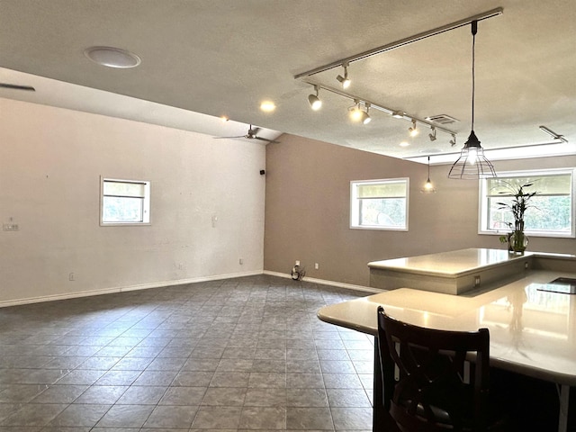 kitchen with plenty of natural light and hanging light fixtures