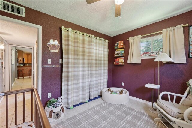 233 Spooner St, Orange, TX 77630 - bathroom featuring a textured ceiling, baseboards, ceiling fan, and a textured wall