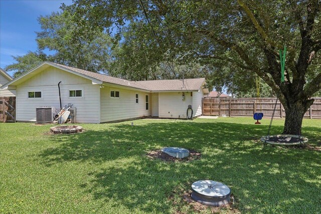 233 Spooner St, Orange, TX 77630 - rear view of property with cooling unit and an outdoor fire pit