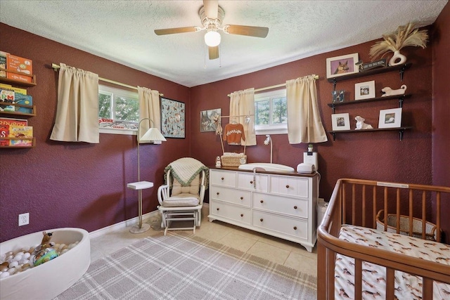 233 Spooner St, Orange, TX 77630 - bedroom with multiple windows, a textured ceiling, a textured wall, tile patterned floors, and baseboards