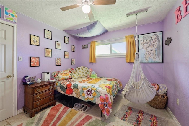 233 Spooner St, Orange, TX 77630 - bedroom featuring a textured ceiling, a ceiling fan, baseboards, and light tile patterned floors