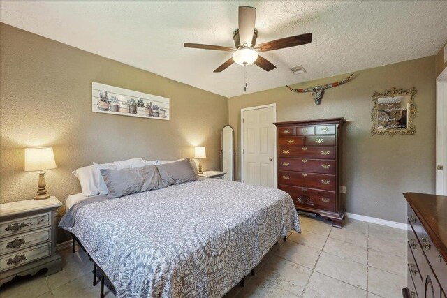 233 Spooner St, Orange, TX 77630 - bedroom featuring baseboards, a ceiling fan, and light tile patterned floors